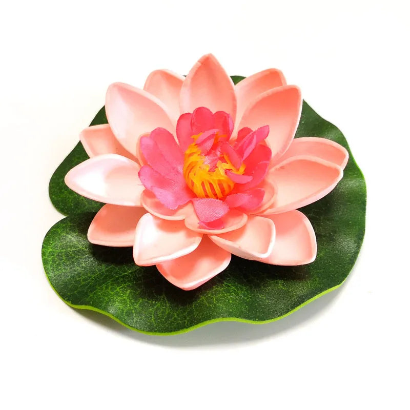 A lifelike pink lotus flower with a vibrant orange center rests on a green leaf.