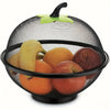 A black metal fruit basket with a mesh cover filled with various fruits and topped with a green leaf handle.