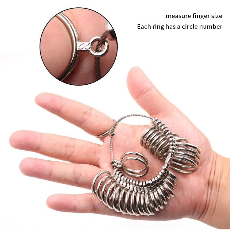 A hand holds a metal ring sizing gauge with multiple conical rings for measuring finger size.