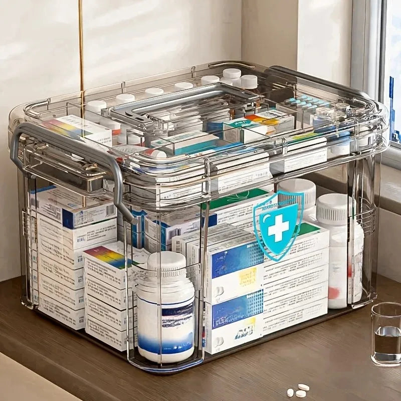 A transparent plastic first aid storage box with a handle filled with various medical supplies and bottles.