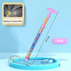 A pink fireworks water blaster toy with a purple handle is shown spraying water into a blue basin.