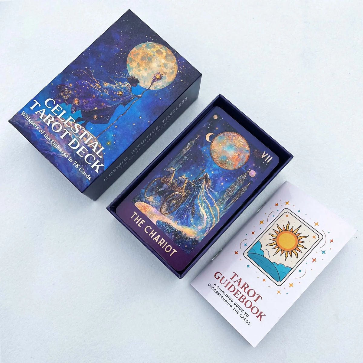A box of the Celestial Tarot Deck featuring a moon and stars, next to a Tarot guidebook.
