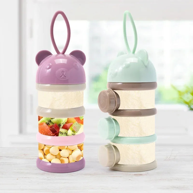 A set of three stackable bear-shaped baby food storage containers in purple, green, and beige.