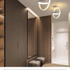 Modern clover LED ceiling light fixture with a circular design mounted on a wall.
