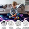 A boy sits on a couch with a purple blanket featuring a cat design and various fabric swatches.