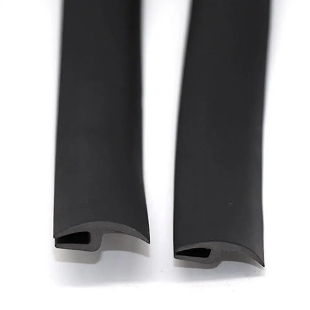 A pair of black flexible rubber windshield seal strips.