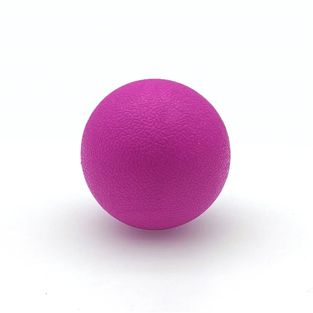 A vibrant magenta TPE peanut massage ball resting on a white surface.