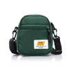 A dark green Japanese style mini canvas crossbody bag with black strap and a yellow tag.