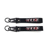 Black leather keychain with red text spelling TOUGE DREAMS