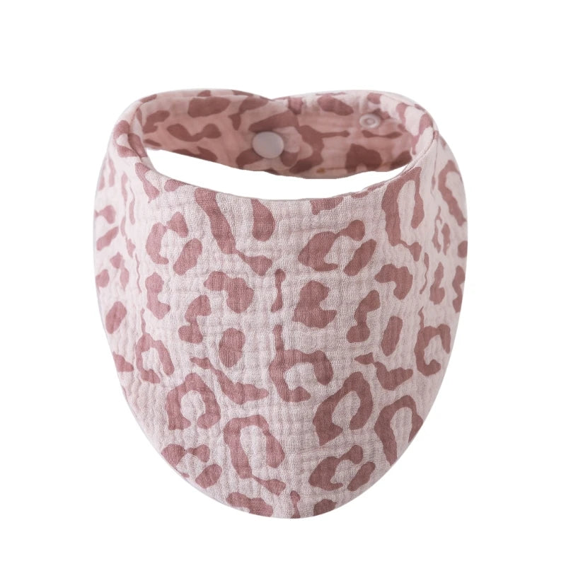 A pink leopard print organic cotton muslin baby bib with an absorbent band.