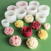A collection of white and pink silicone molds shaped like roses and peonies for crafting.