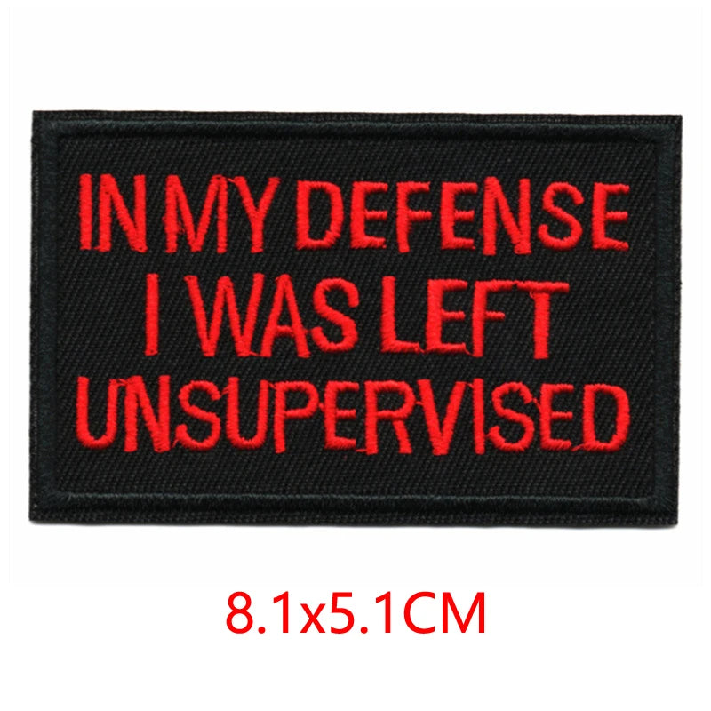 Black embroidered iron-on letter patch with red text that reads In My Defense I Was Left Unsupervised