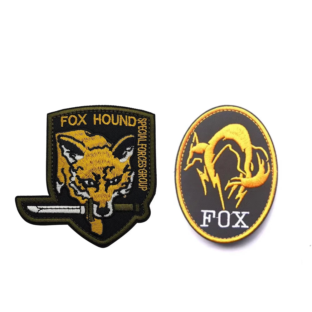 An embroidered patch featuring a stylized fox head and lightning bolt design with the word FOX on a black background.