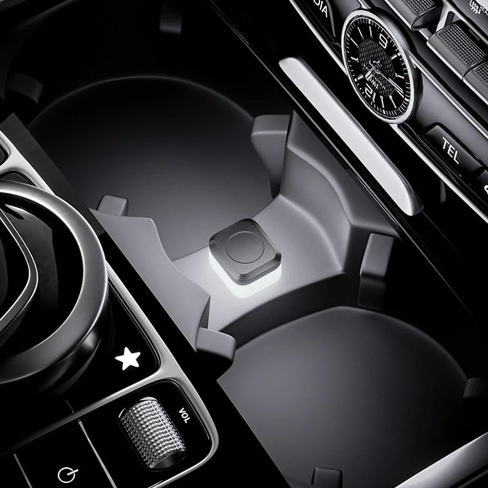 Close-up view of a car interior showing a USB powered compact LED ambient light switch and controls.