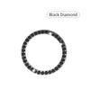 A black diamond ring with a round band and pave-set stones.