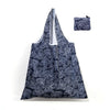 A navy blue patterned reusable shopping tote bag and a matching small carry pouch.