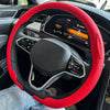 A red breathable leather steering wheel cover installed on a car's steering wheel.