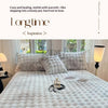 A white faux fur fitted sheet and pillowcase set displayed on a bed with soft lighting.