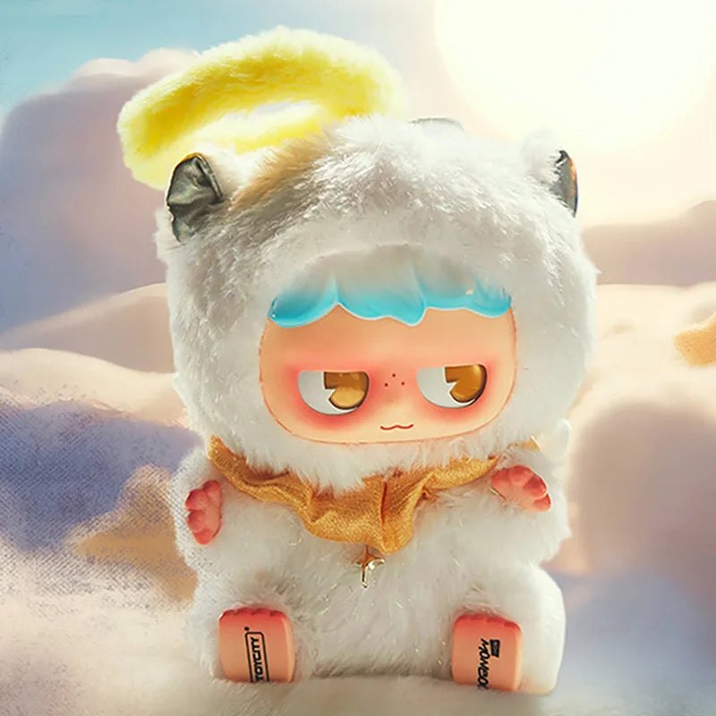 A fluffy white monster plush toy with yellow hair and blue accents sitting in a sandy outdoor setting.