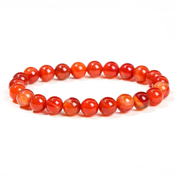 A bracelet made of smooth, polished, reddish-orange natural stone beads.