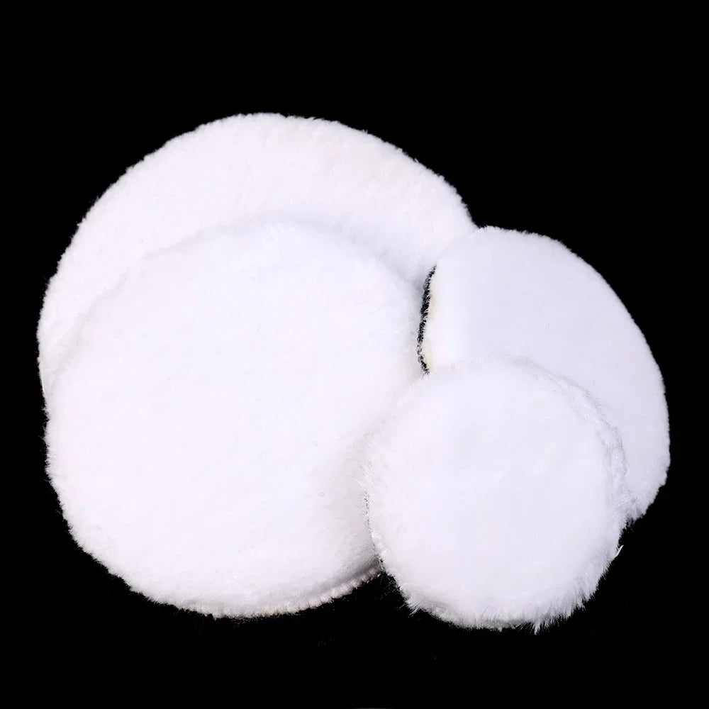 A set of white wool polishing pads for car detailing