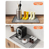 A set of silicone mats, including a rain gear mat and a coffee mat, are displayed on a kitchen counter.