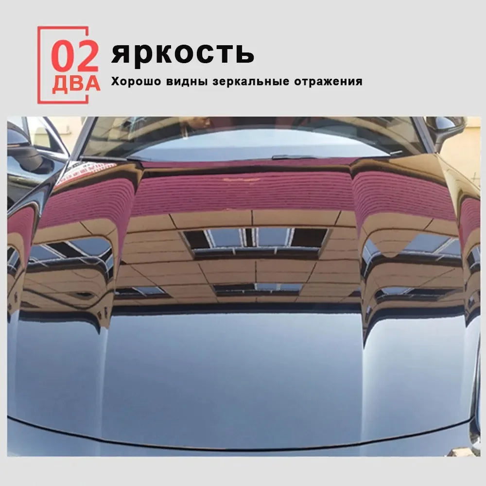 Close-up view of a car's hood showing reflections and a red textured coating.