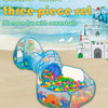 A colorful three-piece play tent with a tunnel and ball pit is set up on a sandy beach with the ocean in the background.