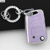 A silver key ring attached to a purple TPU car key cover for VW, SEAT & Skoda models.