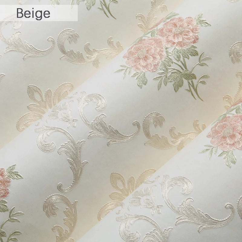 Beige wallpaper featuring embossed floral and scroll patterns with soft pink accents.