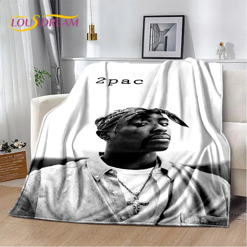A throw blanket featuring a black and white portrait of Eminem and 2Pac hip-hop icons.