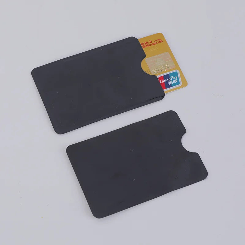 A set of ten black RFID blocking card sleeves next to a yellow UnionPay credit card.