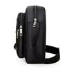 Black water-resistant multi-pocket crossbody chest bag with a zippered top and adjustable strap.
