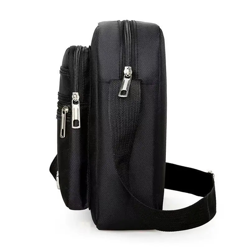 Black water-resistant multi-pocket crossbody chest bag with a zippered top and adjustable strap.