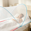 A white mosquito net with a blue trim is shown covering a bed, demonstrating increased surround space.