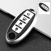 A close-up view of a silver TPU key fob cover with multiple buttons and a protective black sleeve.