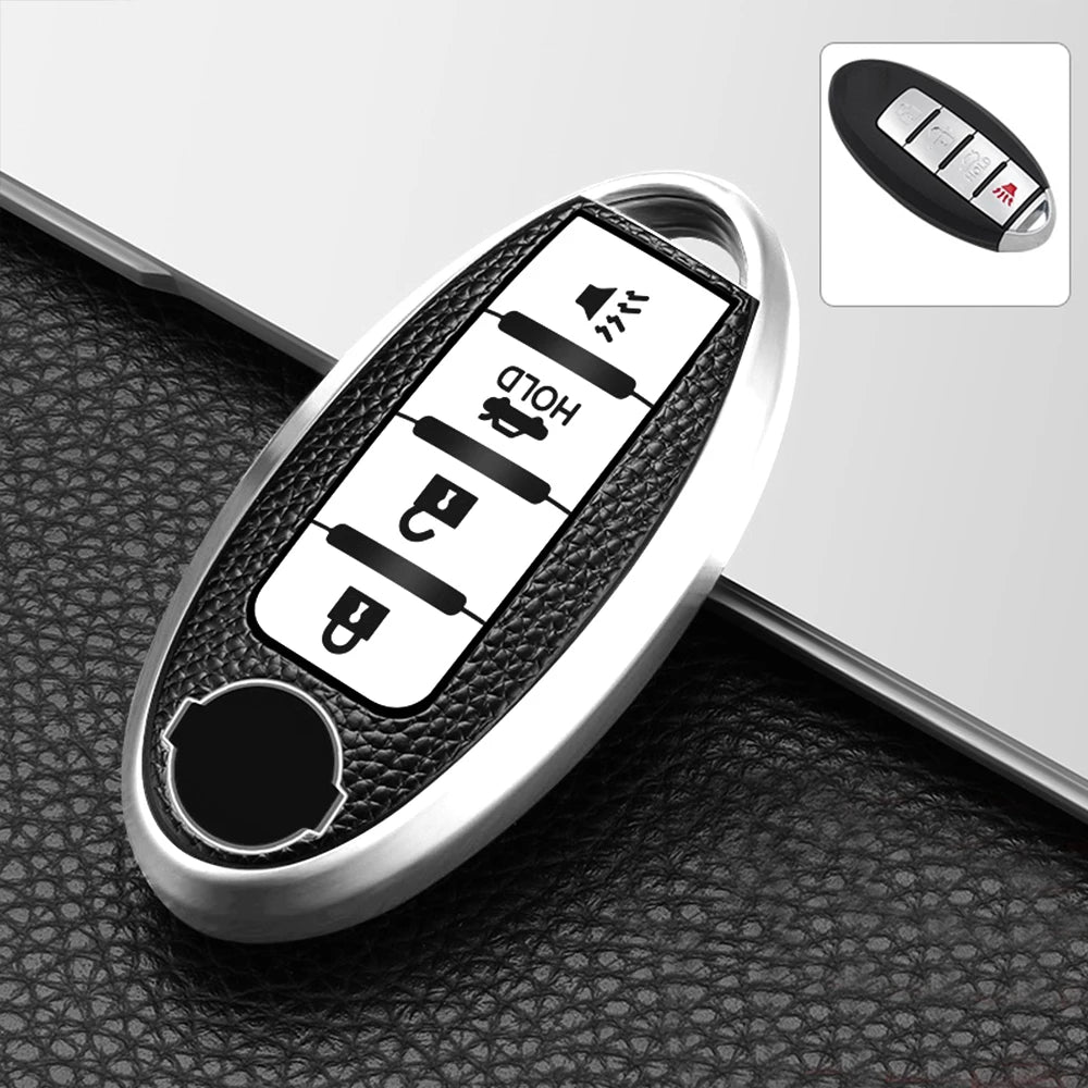 A close-up view of a silver TPU key fob cover with multiple buttons and a protective black sleeve.