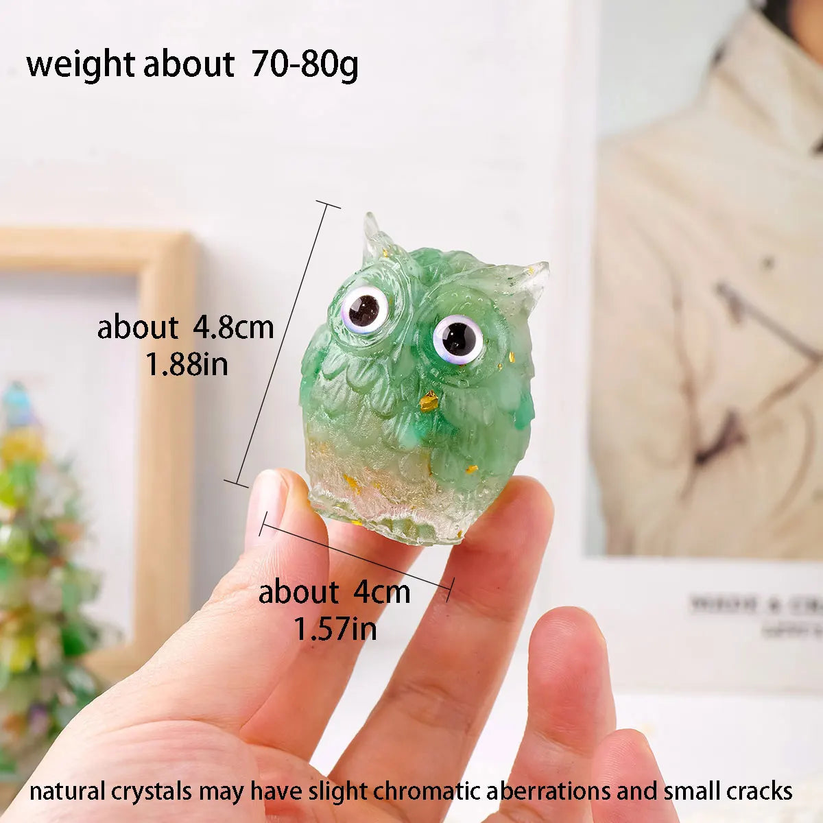 A hand holds a handcrafted crystal owl figurine with a natural crushed stone finish, showing its size and detail.