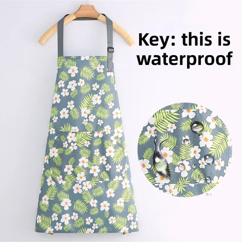 A light blue floral print kitchen apron hanging on a wooden hanger with a waterproof label.