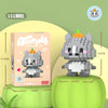 A gray animal figurine is displayed on a green surface next to its packaging box.