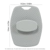 A gray silicone body scrubber and massage brush with a textured surface and a central oval pad.