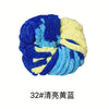 A ball of chunky acrylic yarn featuring a blend of royal blue, light blue, and yellow fibers.
