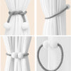 Silver pearl magnetic curtain tiebacks with a strong hold used to secure white fabric curtains.