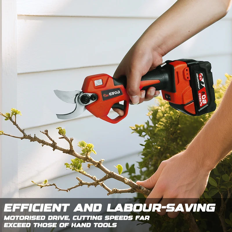 A hand is using an orange and black cordless electric pruning shear on a tree branch.