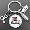 Silver keychain featuring a glass dome charm with the text I Love Nursing and a medical syringe charm.