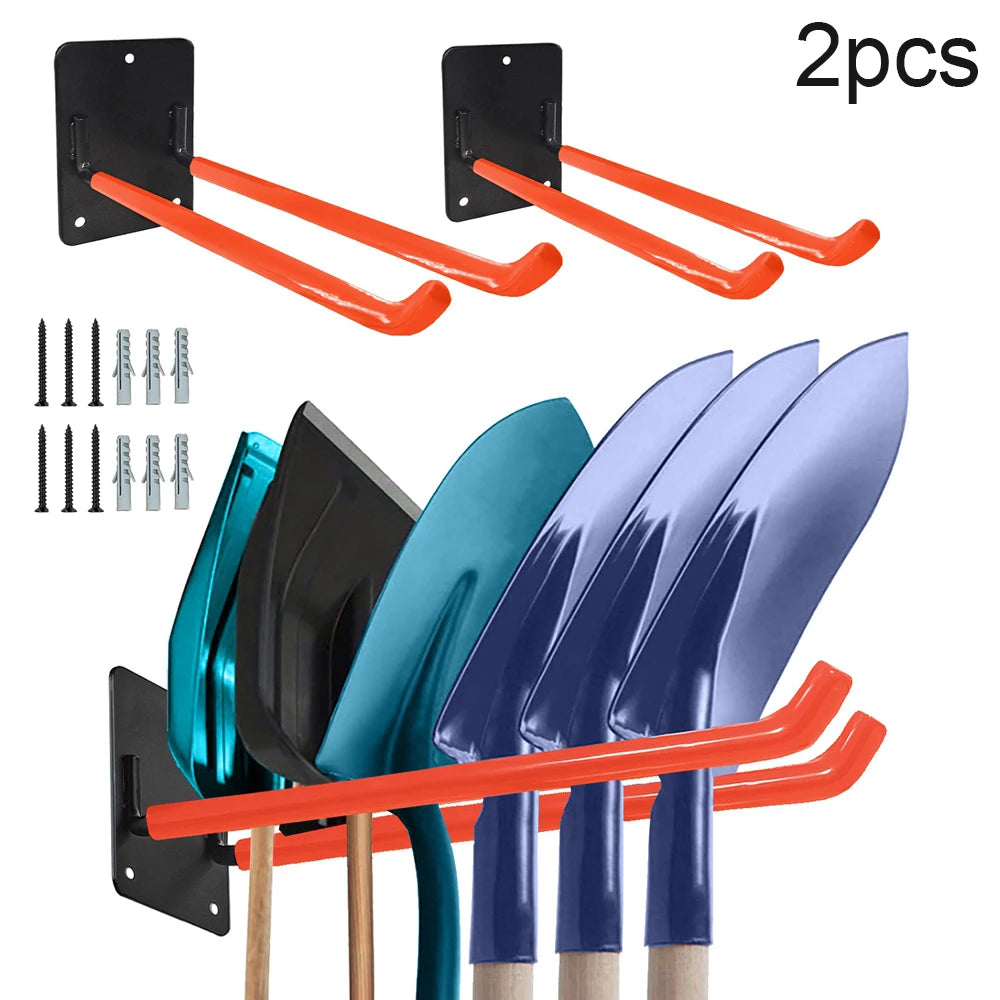 Two black wall mounts with orange handles and a set of five garden tools displayed below.