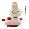A white compact hand-operated yarn ball winder with a red base and a metal rod.