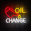 Neon sign displaying the words OIL CHANGE in red and yellow against a dark grid background.