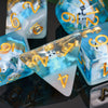 A close-up of a set of translucent blue and white resin dice, including a triangular die, resting on a dark reflective surfac