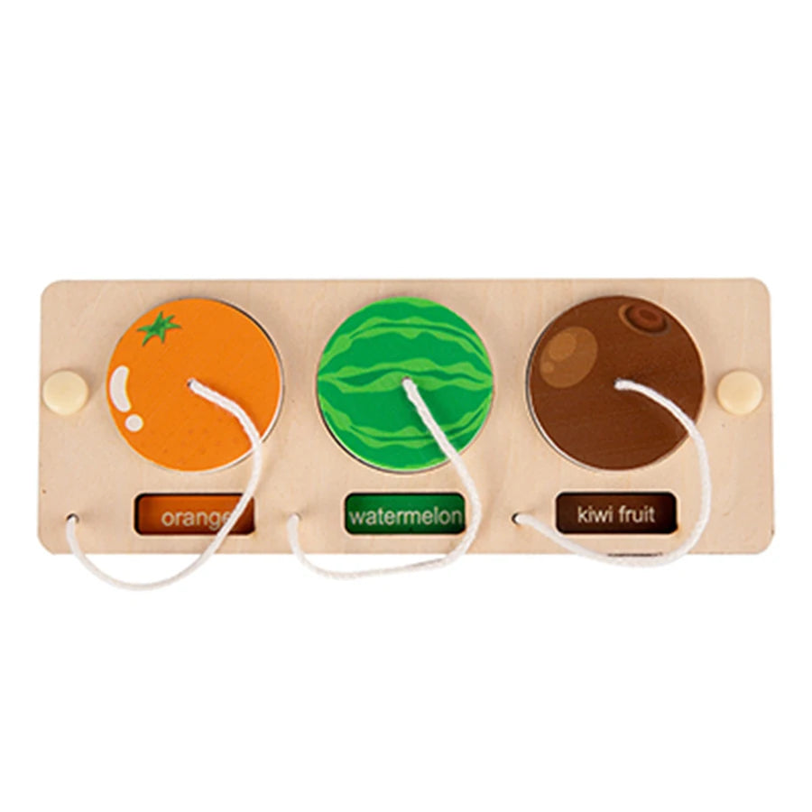 A wooden busy board featuring three fruit shapes: orange, watermelon, and kiwi fruit.